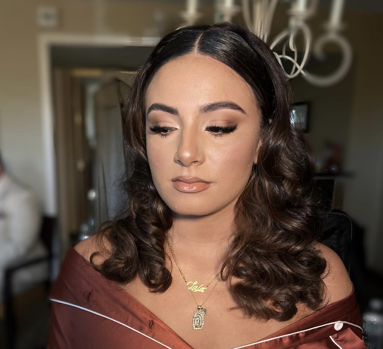 Close-up soft glam makeup artistry with closed eyes, finished bridal-prep look